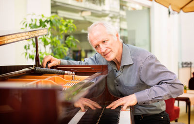 Portrait of man playing at music concert