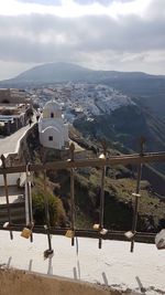 Scenic view of buildings in town against sky