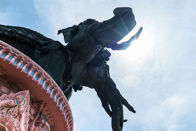 Low angle view of statue against cloudy sky