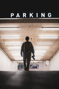 Rear view of man standing in subway