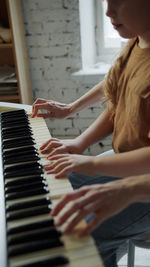 Side view of woman playing piano