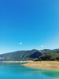 Scenic view of mountains against clear blue sky