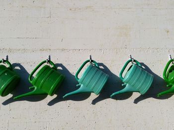 Panorama of green watering cans