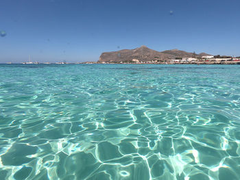 Scenic view of sea against clear blue sky