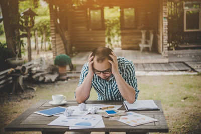 Man sitting outdoors at table