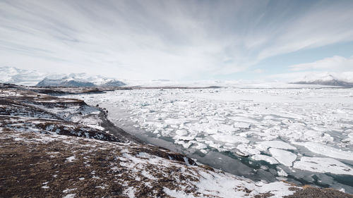 Scenic view of frozen lake against sky