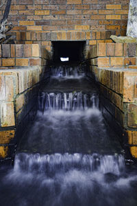 Scenic view of waterfall against wall