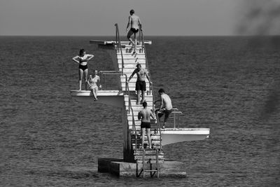 Lifeguard hut on sea against sky