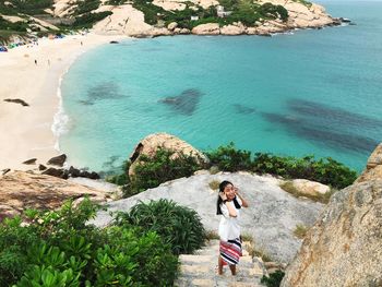 Portrait of woman standing at beach