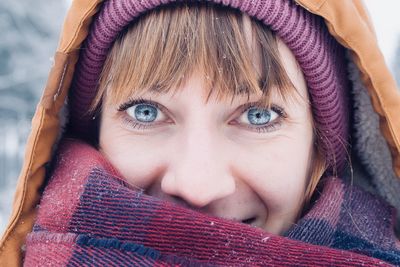 Close-up portrait of a boy in snow