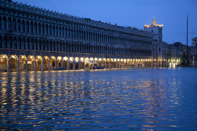 Reflection of building in water at night