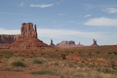 Rock formations on landscape against sky