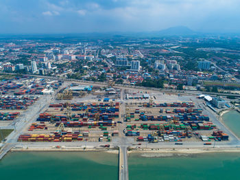 High angle view of cityscape by sea against sky