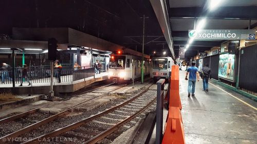 Train on railroad station platform at night