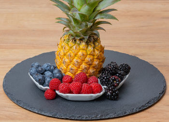 Close-up of pineapple in plate on table