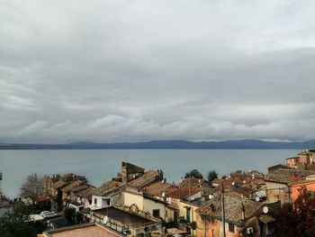 High angle view of townscape by sea against sky