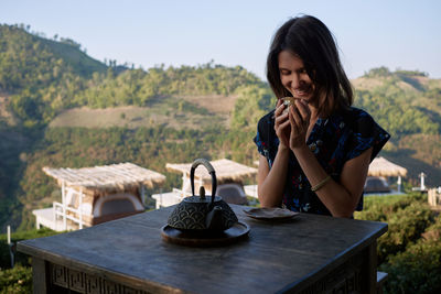 Woman drinking tea in garden