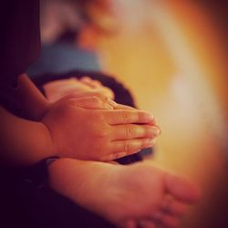 Low section of boy praying at buddhist temple