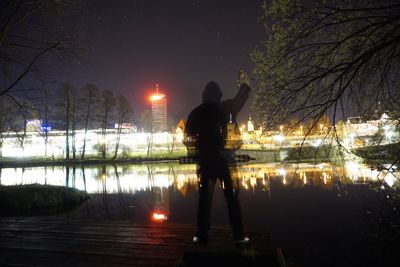 Reflection of woman in water at night