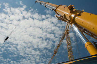 Low angle view of crane against sky