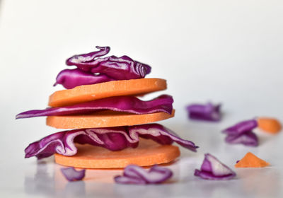 Close-up of cake on table against white background