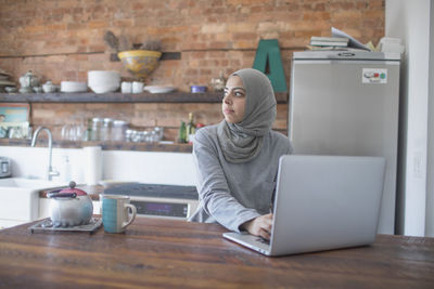 Man using laptop in coffee cup