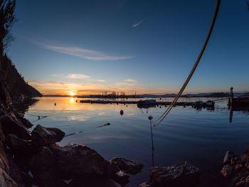 Scenic view of lake against sky during sunset