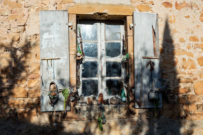 The closed window of an old building