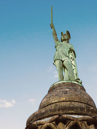 Low angle view of statue against blue sky