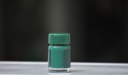 Close-up of green bottle on table