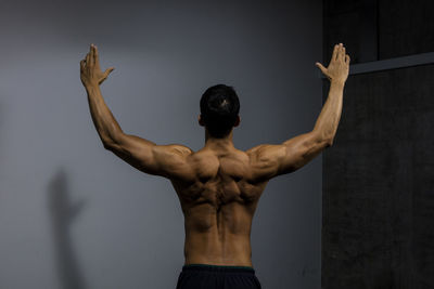 Rear view of shirtless muscular man