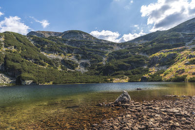 Scenic view of lake and mountains against sky