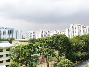 High angle view of trees and buildings against sky