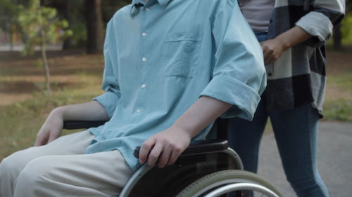 Midsection of man sitting on field