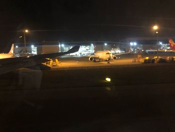 Illuminated airport runway at night