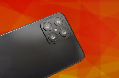 Close-up of remote control on yellow background