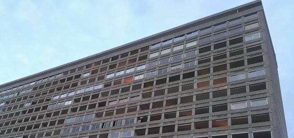 Low angle view of office building against sky