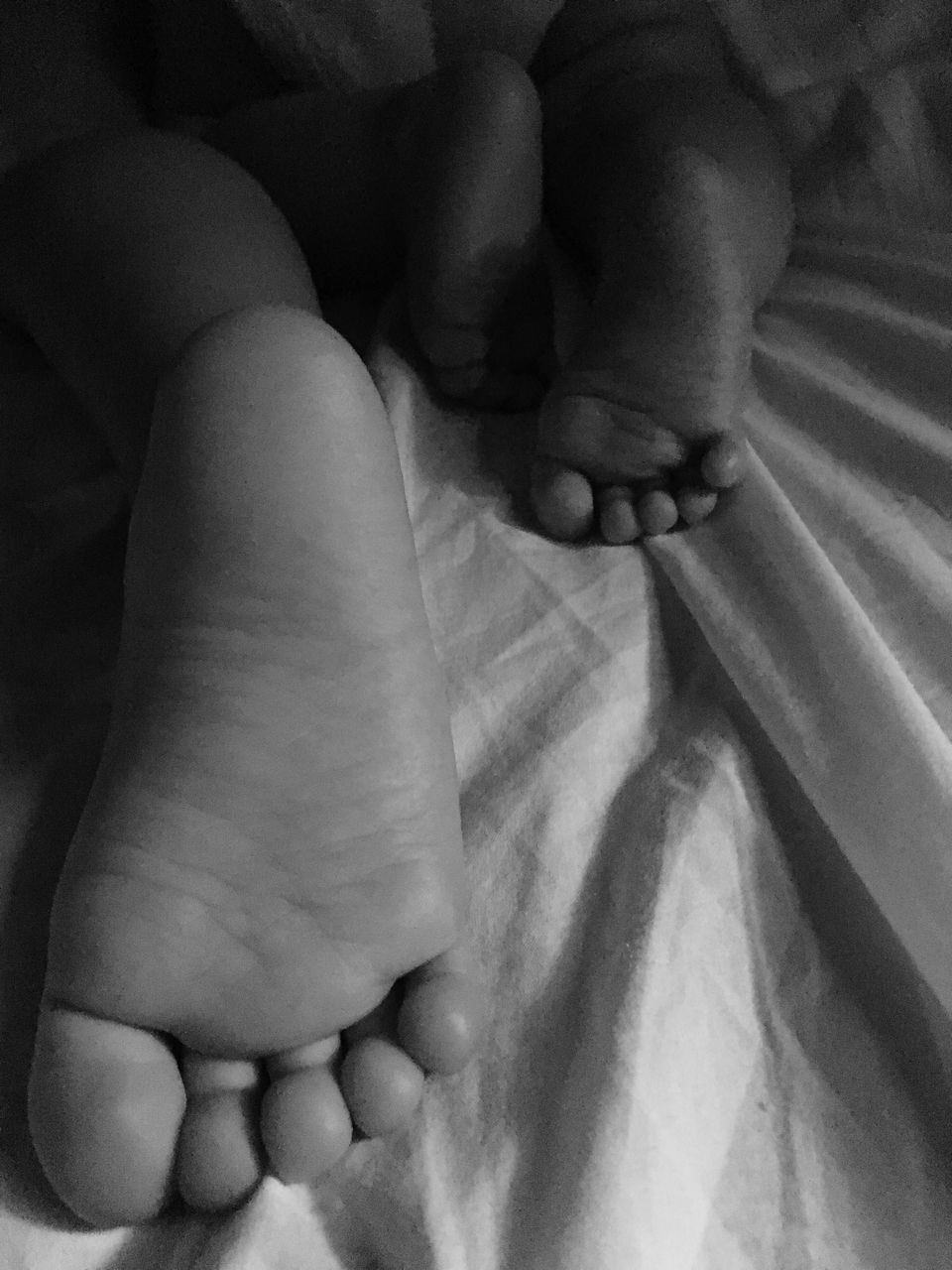 LOW SECTION OF BOY SLEEPING ON BED