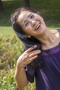 Portrait of a smiling young woman in field