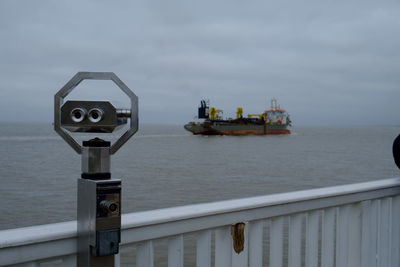 Container ship in sea against sky