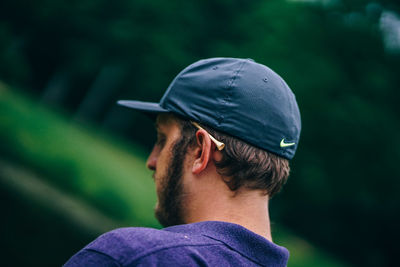 Rear view of man looking away outdoors