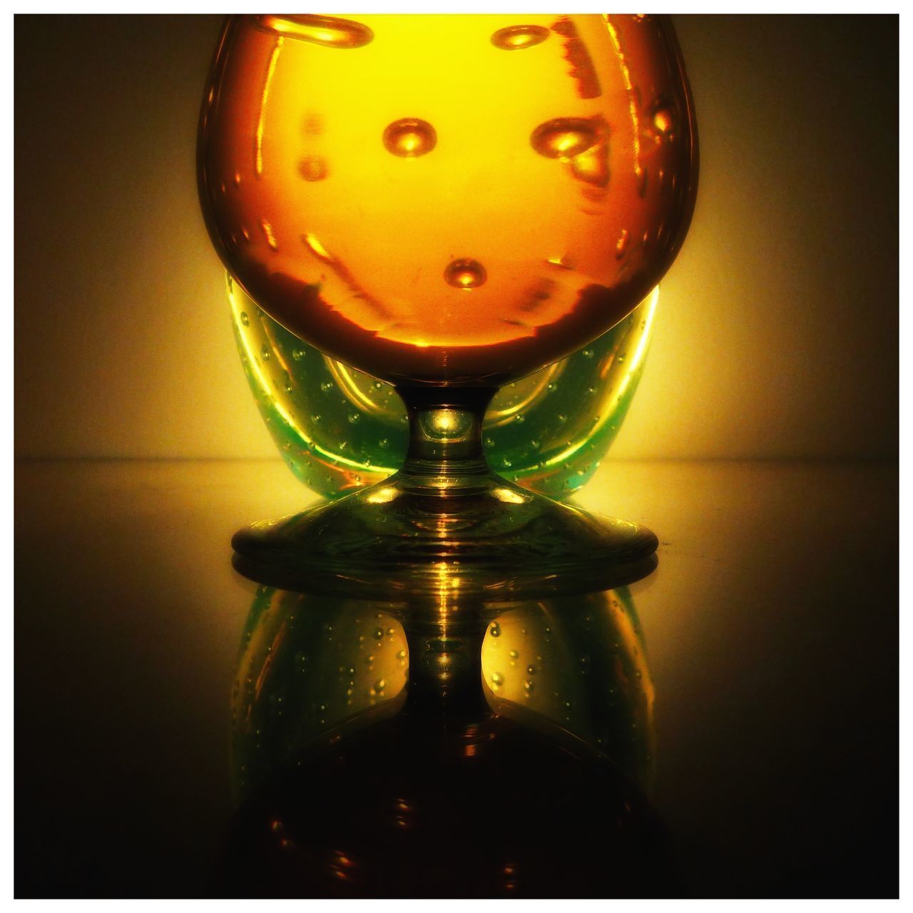 CLOSE-UP OF DRINK ON GLASS TABLE