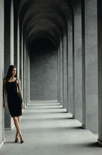 Woman standing in corridor of building