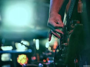 Midsection of man playing guitar