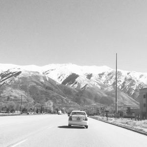 Road passing through snow covered mountains