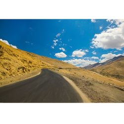 Empty road leading towards mountains