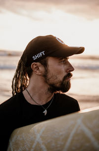 Portrait of young man looking away over sea