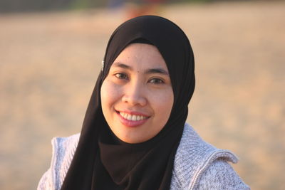 Close-up portrait of smiling young woman wearing hijab