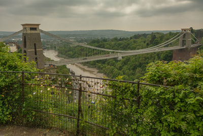 View of suspension bridge against cloudy sky