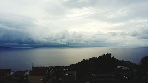 Scenic view of sea against storm clouds